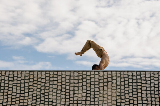 Parkour athlete sitting on edge 