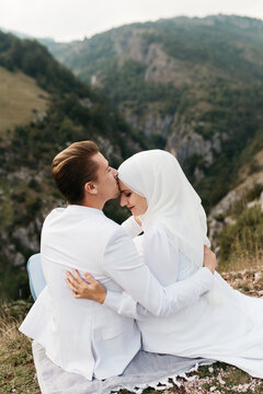 Happy couple sitting in the mountains 