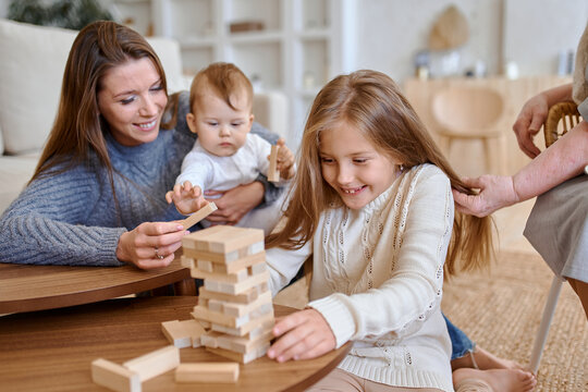 family plays jenga at home