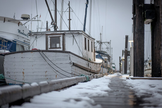 White boat on a snowy winter dock in British Columbia