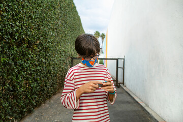 Young man checking phone in alley