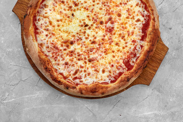 Selective focus traditional stone-baked pizza Margarita on stone table