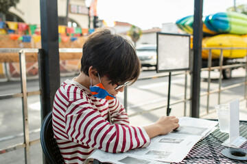 Boy reading local news in California town