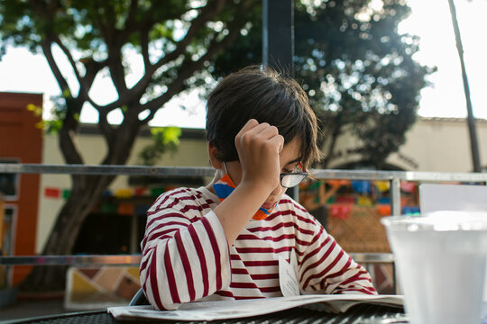Boy reading news at street parklet