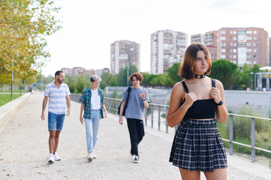Young person walking on a park path