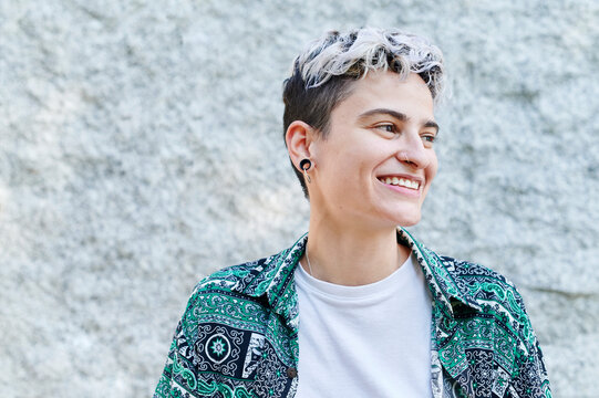 Laughing young person standing outside