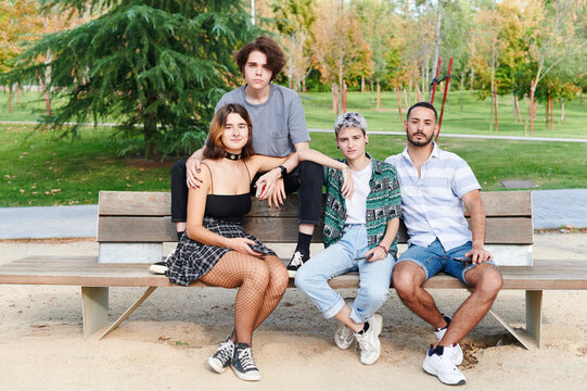 Young lgbt friends sitting on a park bench