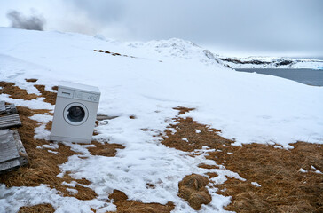 White goods, consumer washing machine in Arctic wilderness