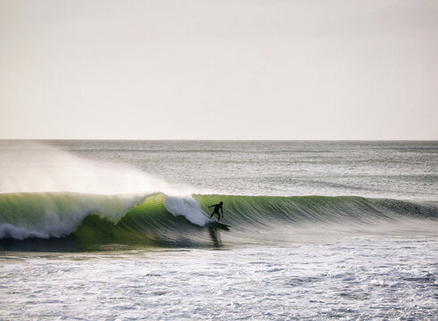 A lone surfer pulls into a left hander on Auckland's west coast. 