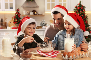 Happy father and his children making dough for delicious Christmas cookies at home