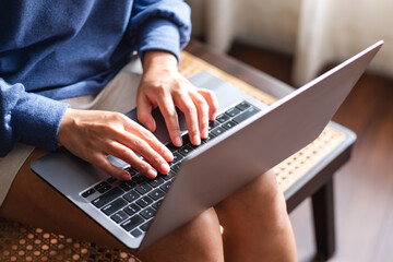 Closeup of a woman working and typing on laptop computer keyboard