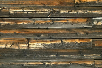Close-up view of old wooden wall of rusty house. Beautiful wooden texture.