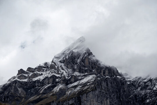 An Alpine mountain range covered in snow in Switzerland. - Powered by Adobe
