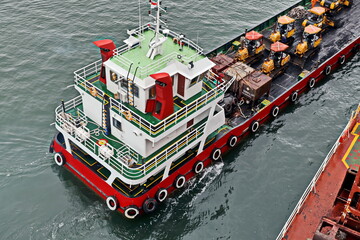 Various views of vessels and tugboats in port. Close-up view of the ships and barges construction....