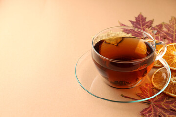 Concept of hot drink with tea on beige background