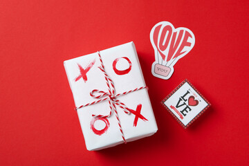 Valentine's Day concept with tic tac toe on gift box on red background