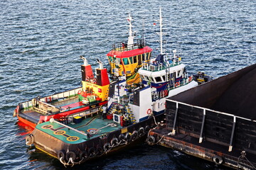 Various views of vessels and tugboats in port. Close-up view of the ships and barges construction....