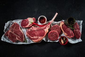 Raw beef steaks and cutlets with chili pepper and spices