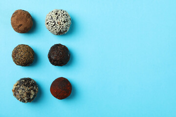 Flat lay composition with truffles on blue background