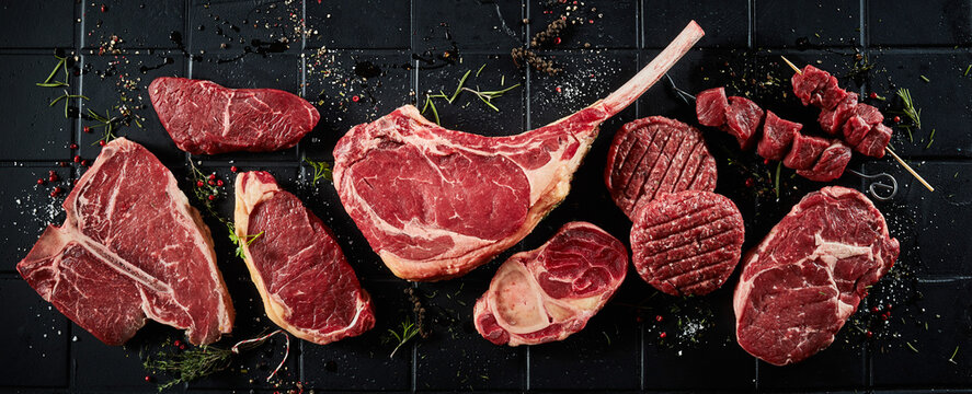 Raw beef steaks cutlets and shish kebab and seasonings