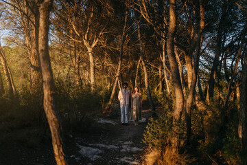 Couple standing still in the forest