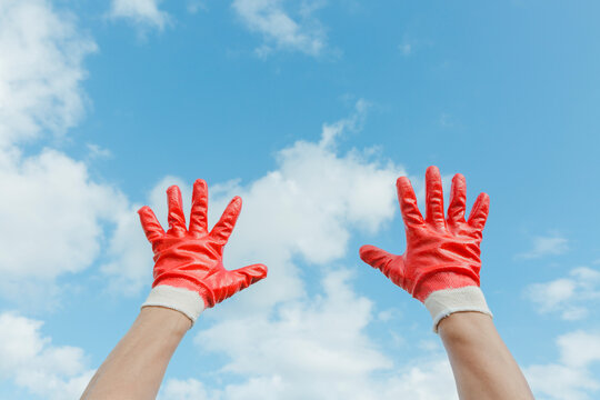 Hands wearing red gloves.