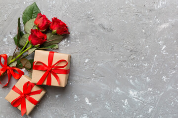 Valentine's day composition with rose flower, red heart and gift boxes on table. mother day and birthday greeting, copy space, top view