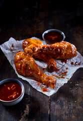 Fried chicken legs placed on wooden table