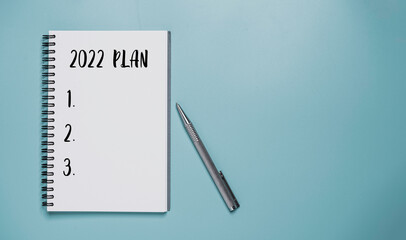 2022 plan on notebook with pen for preparation new business plan and target of new year.