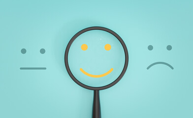 Yellow smile face inside of magnifier glass between sad and normal emotion for focus positive emotion concept. - obrazy, fototapety, plakaty