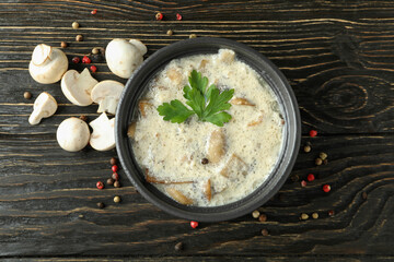 Concept of tasty food with mushroom sauce on wooden background
