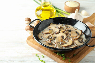 Concept of tasty food with mushroom sauce on white wooden background