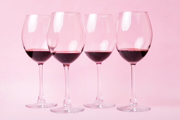Many glasses of red wine at wine tasting. Concept of red wine on colored background. Top view, flat lay design