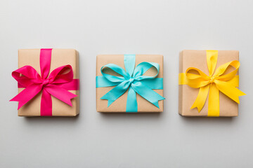 Holiday present box over colored background, top view