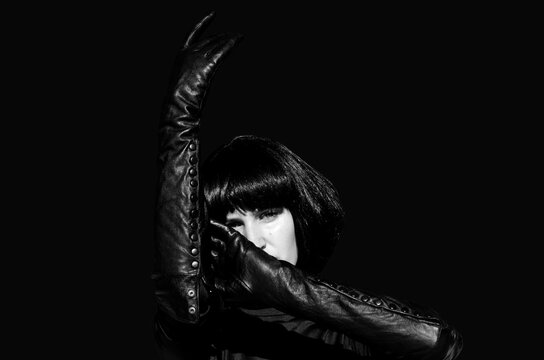 Portrait of a woman in long leather gloves