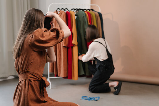 Woman taking photo of creative dressmaker