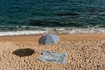 Minimal pic with Umbrella and towel on empty beach