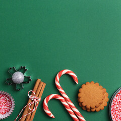 Christmas holiday green square background with empty space. Cookies, sweets, cupcake sprinkles from...
