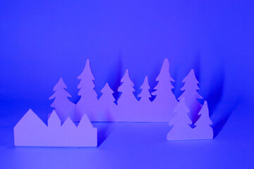 Fototapeta premium Futuristic modern abstract happy New Year 2022, Merry Chrstmas concept. Pine tree from paper on neon bright violet blue background, copy space, banner for your site, invitation, flyer