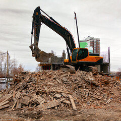 Demolition of an old building by modern excavator.
