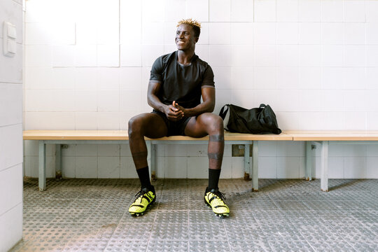 Black male footballer in changing room