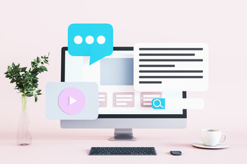 creative pink designer desktop with icons on computer monitor, coffee cup, decorative plnat in vase and keyboard. Technology, communication, work, entertaniment and modern lifestyle concept. 