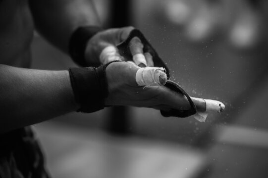 athlete powdering palms with talc before competitions
