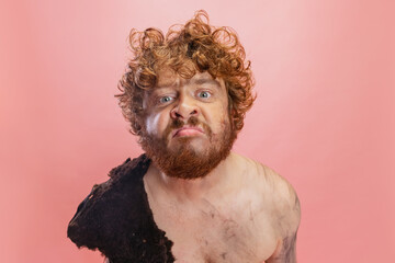 Cropped portrait of man in character of neanderthal, primitive person sniffing into camera isolated...