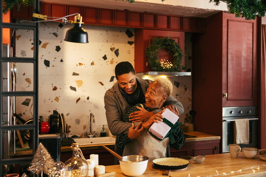 Guy Giving Surprise Gift To Mother