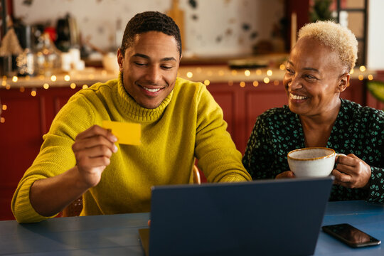 Hispanic mother and son shopping online