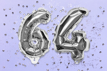 Silver foil balloon number, digit sixty four on a lilac background with sequins. Birthday greeting card with inscription 64. Top view. Numerical digit. Celebration event, template.