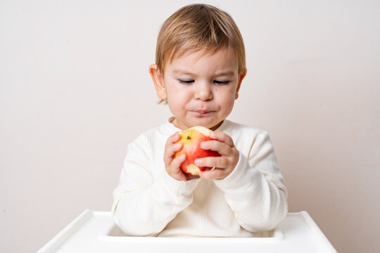 Girl Eating Apple Against White Background