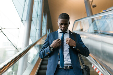 Male entrepreneur going down the escalators