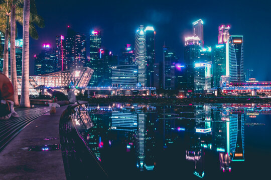 city skyline at night with reflection on the water